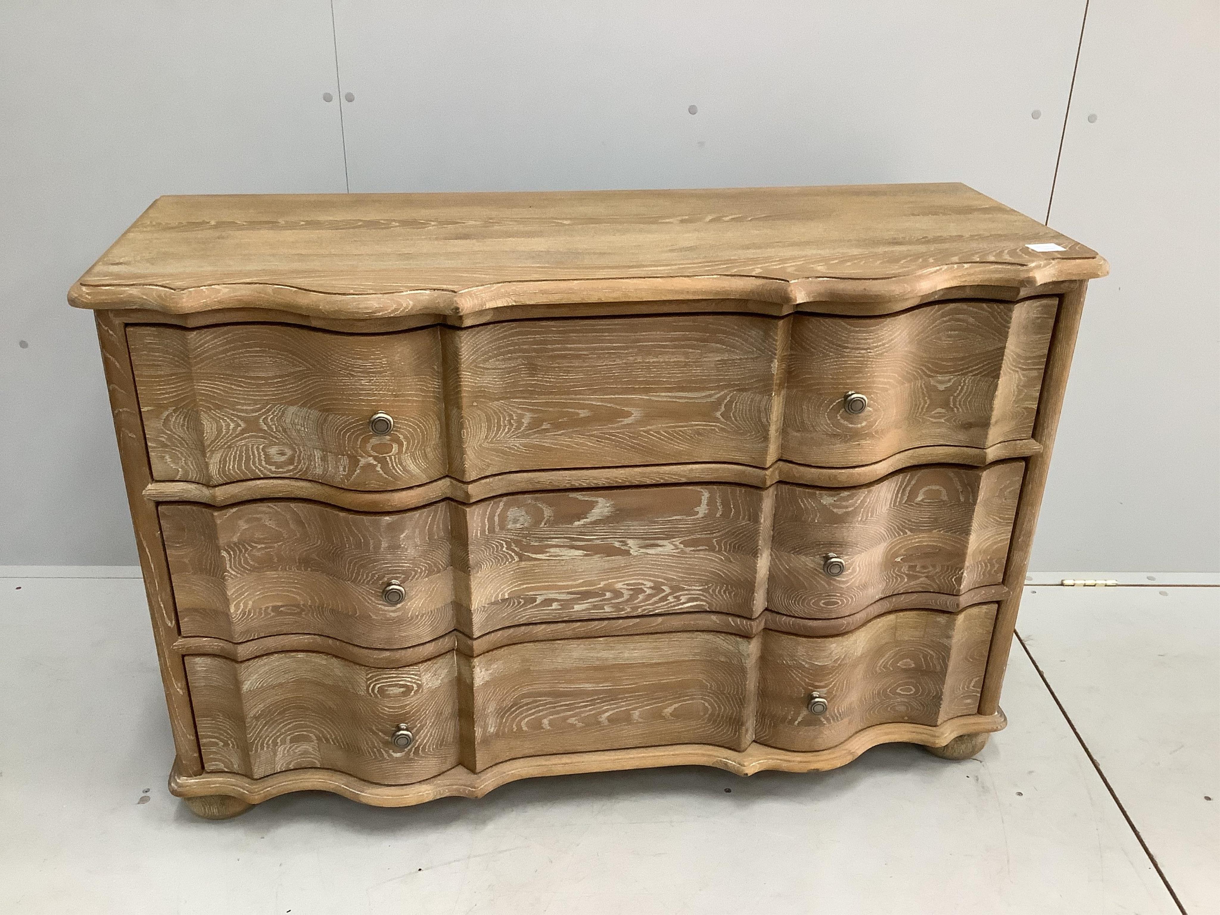 A modern Feather & Black 'Emporium Grande' bleached oak bombe fronted chest of three long drawers, width 124cm, depth 50cm, height 81cm. Condition - good